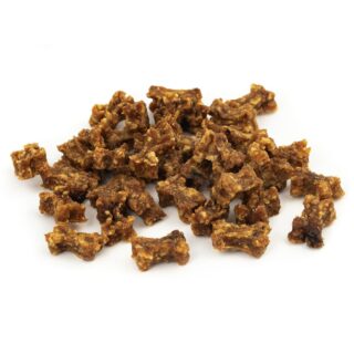 Pile of crispy fried pork cracklings scattered on a white surface, golden brown and chunky.