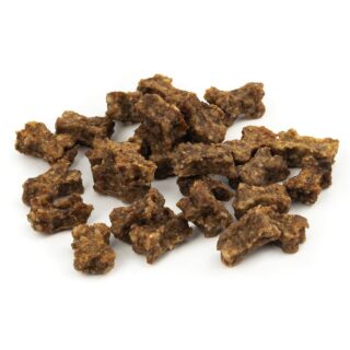 Pile of small, cubed beef jerky bites on a white background, rough textured and brown.