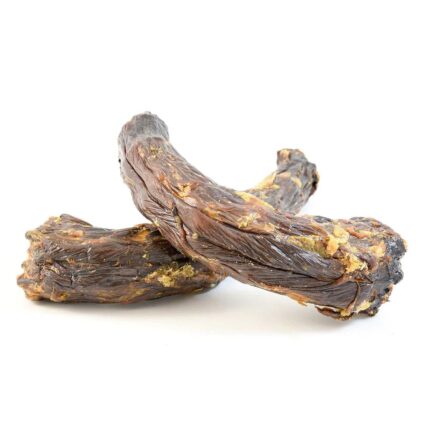 Two strips of beef jerky stacked on a white background, glossy and dark brown with visible fat flecks.